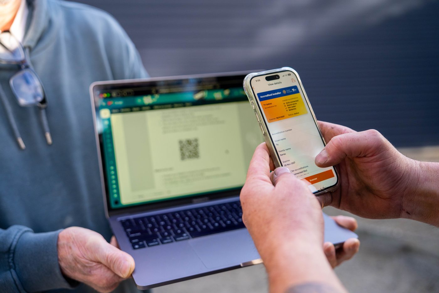 A Goldsure installer walking a Melbourne homeowner through the details on screen
